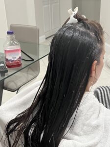 Louse Calls technician performing a professional head lice check using a comb