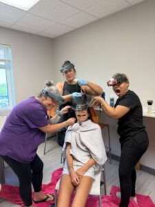 LouseCalls technicians checking a child's hair for head lice during a professional screening